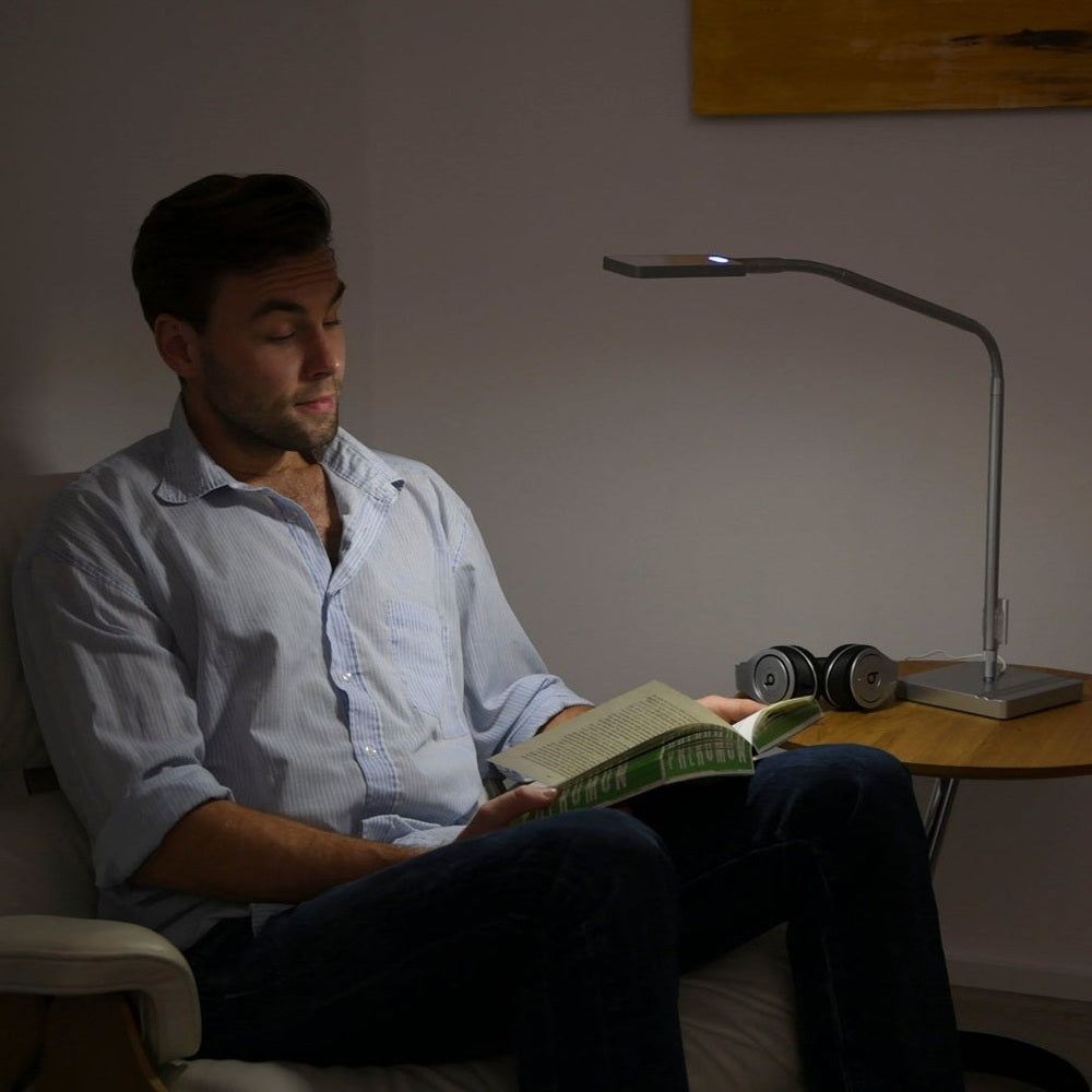 Moll L7 Designer LED Desk Lamp with slim curved arm and built-in LED on a wooden desk