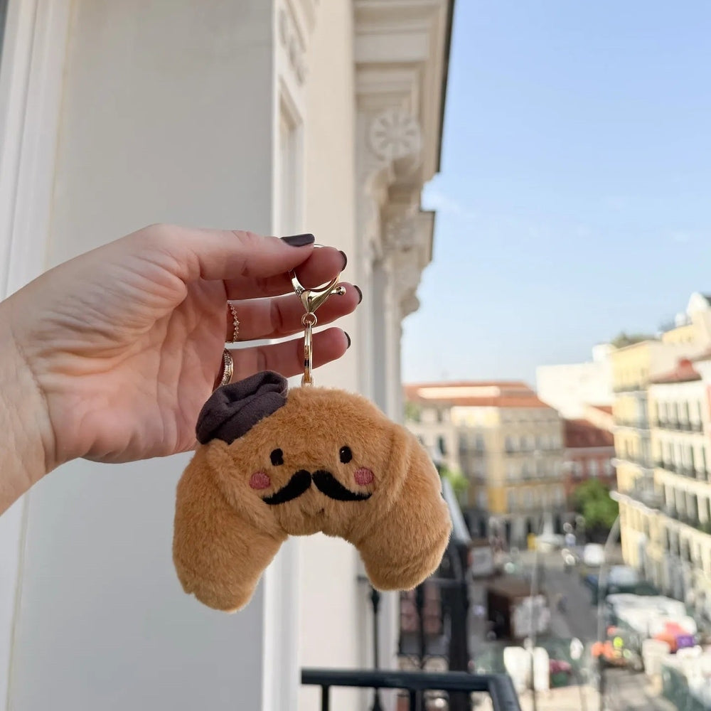 MON AMI Mon Ami Foodie Friends Monsieur Croissant Bag Charm with black beret, mustache, pink cheeks, and metal clasp img 3/5