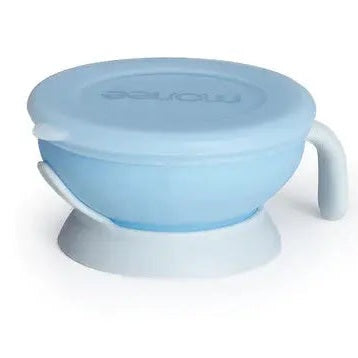 Monee Baby Bowl 150 ml blue silicone with lid and suction base grips table during feeding.