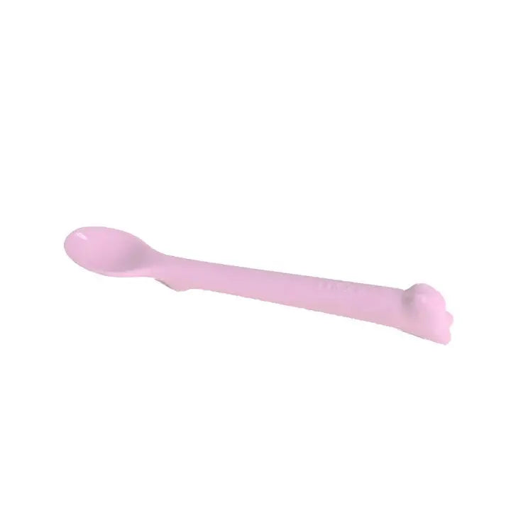 MONEE Baby Spoon Step 2 pink soft-tip feeding spoon with curved handle resting ready for feeding.
