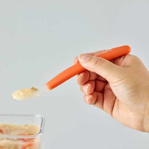 Mother-K silicone baby spoon with orange handle and soft silicone tip