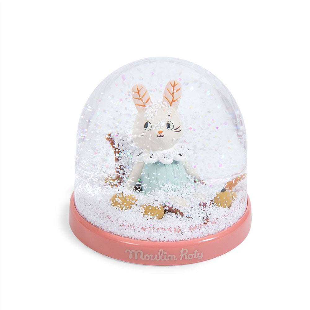 Moulin Roty snow globe featuring a white bunny in a pastel teal dress inside a pink base