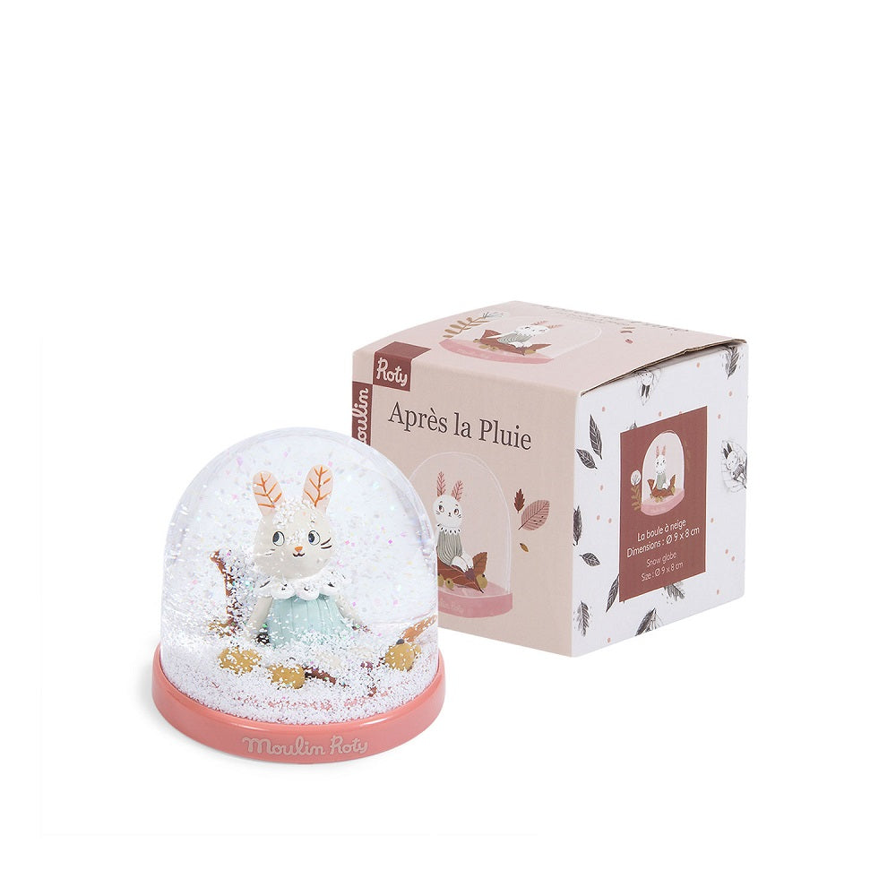 Moulin Roty snow globe with pink base featuring a bunny in a snowy scene; decorative home decor