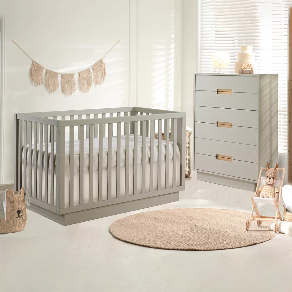 Natart Como Classic Convertible Crib and matching gray dresser in a cozy nursery