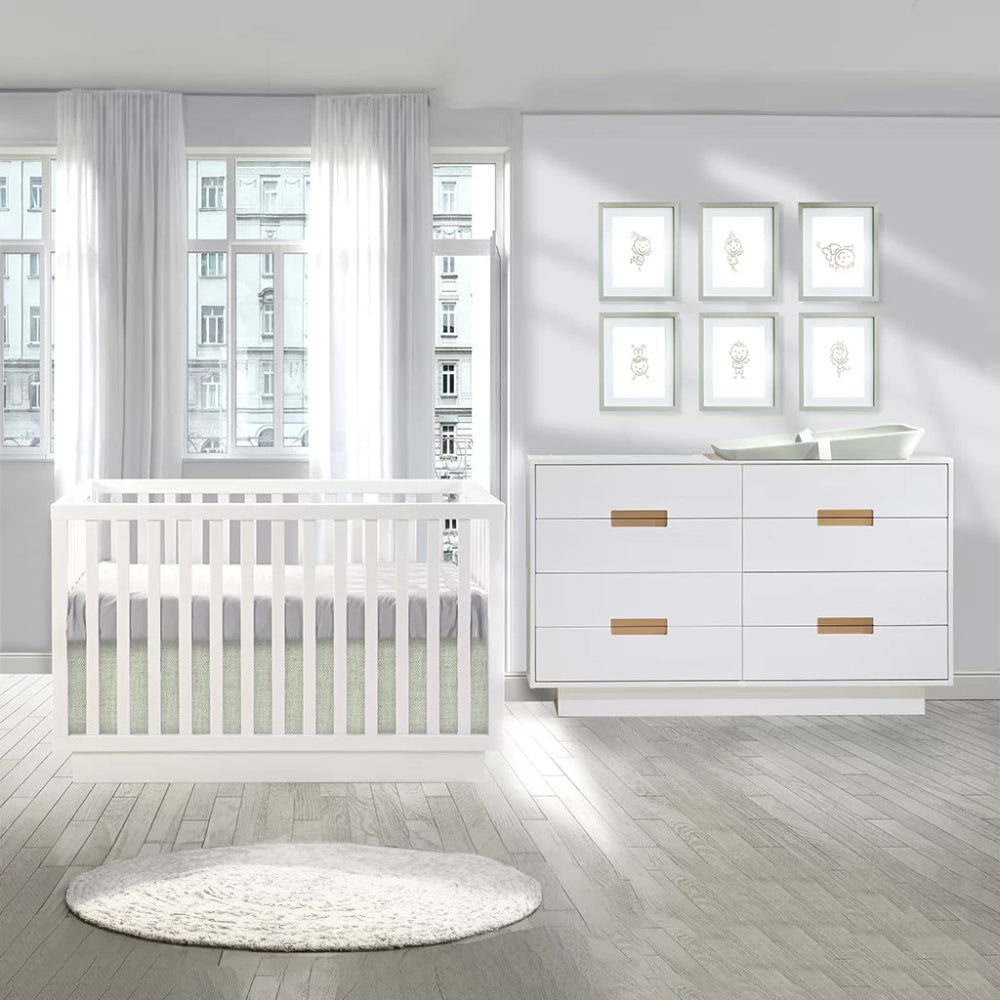Natart Como Classic Convertible Crib and matching white dresser in a bright nursery
