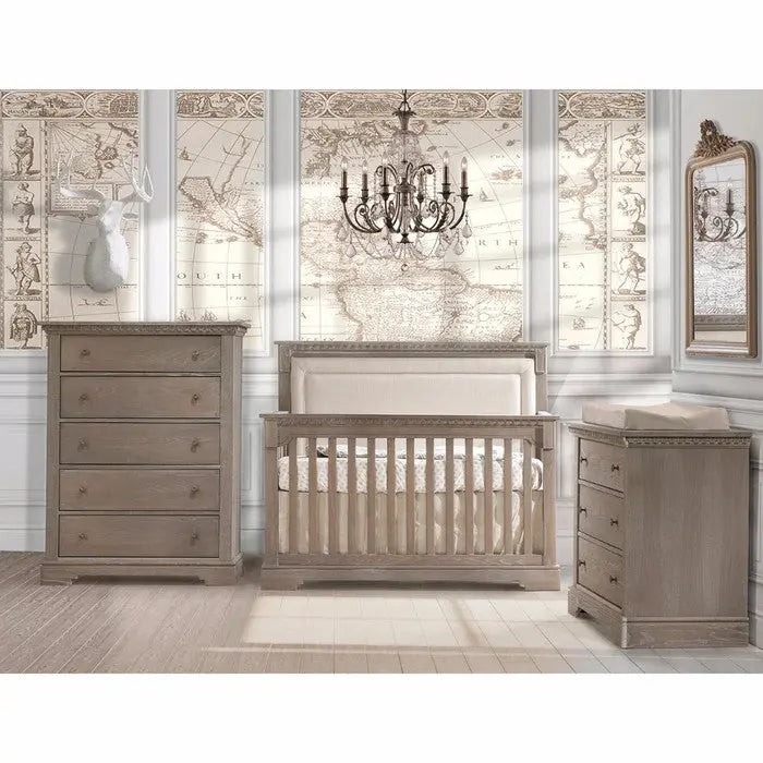 Natart Ithaca 5-In-1 Convertible Crib With Upholstered Headboard Panel in weathered gray, shown with matching dresser and chest.
