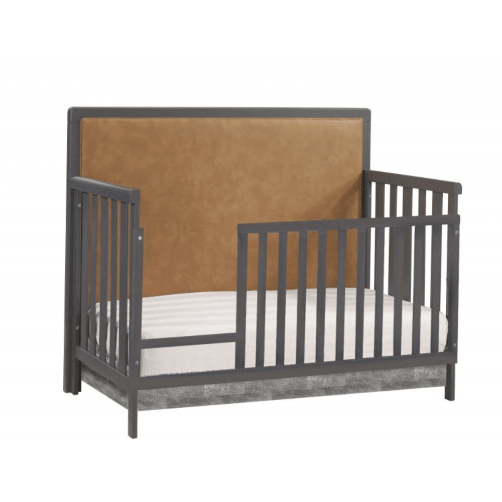 Natart Kyoto 5-in-1 Convertible Crib with gray frame and tan upholstered leather panel.