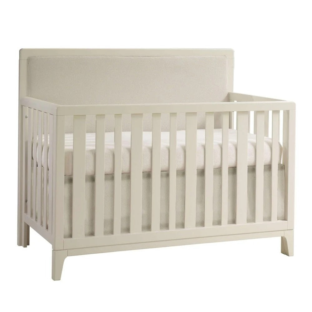 Natart Kyoto 5-in-1 convertible crib with cream upholstered panel and slatted sides