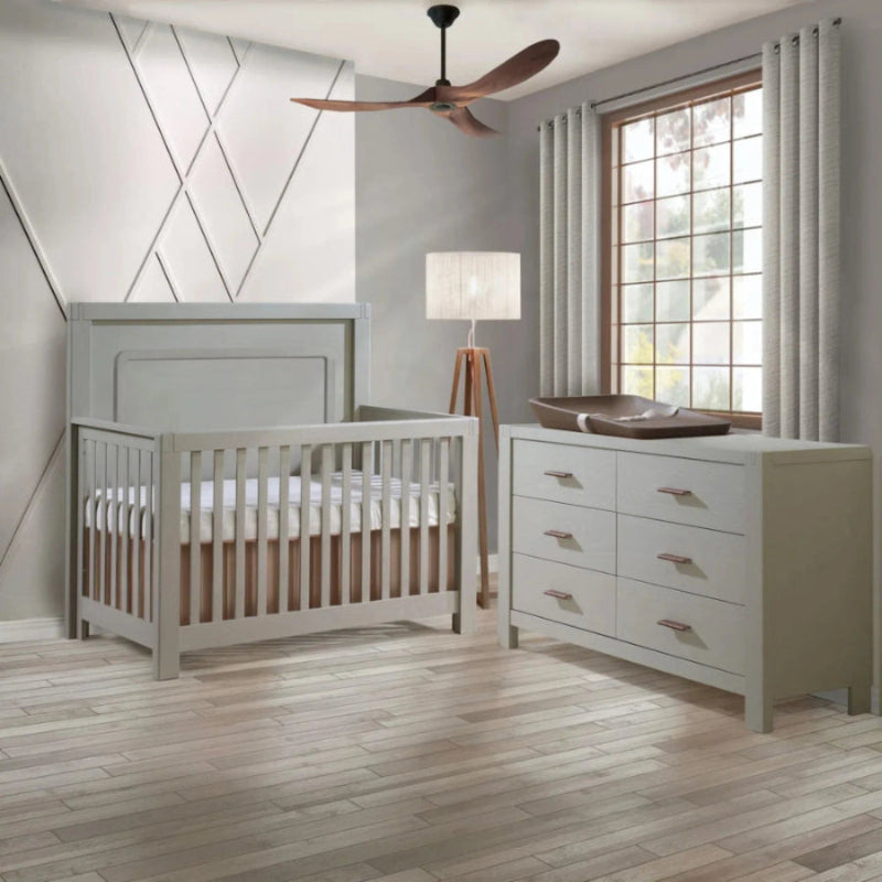 Natart Signature Series Toscano 57 Inch Double Dresser in soft gray with six drawers shown in a calm nursery.