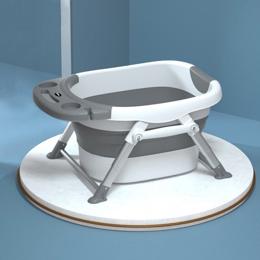 Nemibaby foldable baby/toddler bathtub in grey with white rim and metal legs.