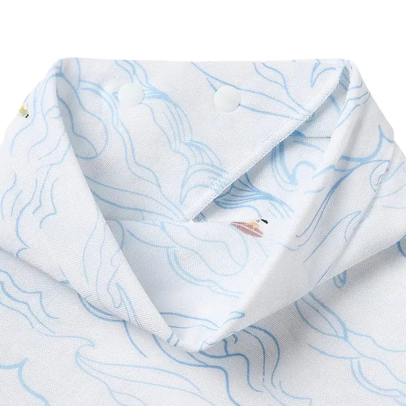 Nest Designs Bamboo Baby Bandana Bib in white with light blue waves; snap buttons show secure fit for 3M-24M
