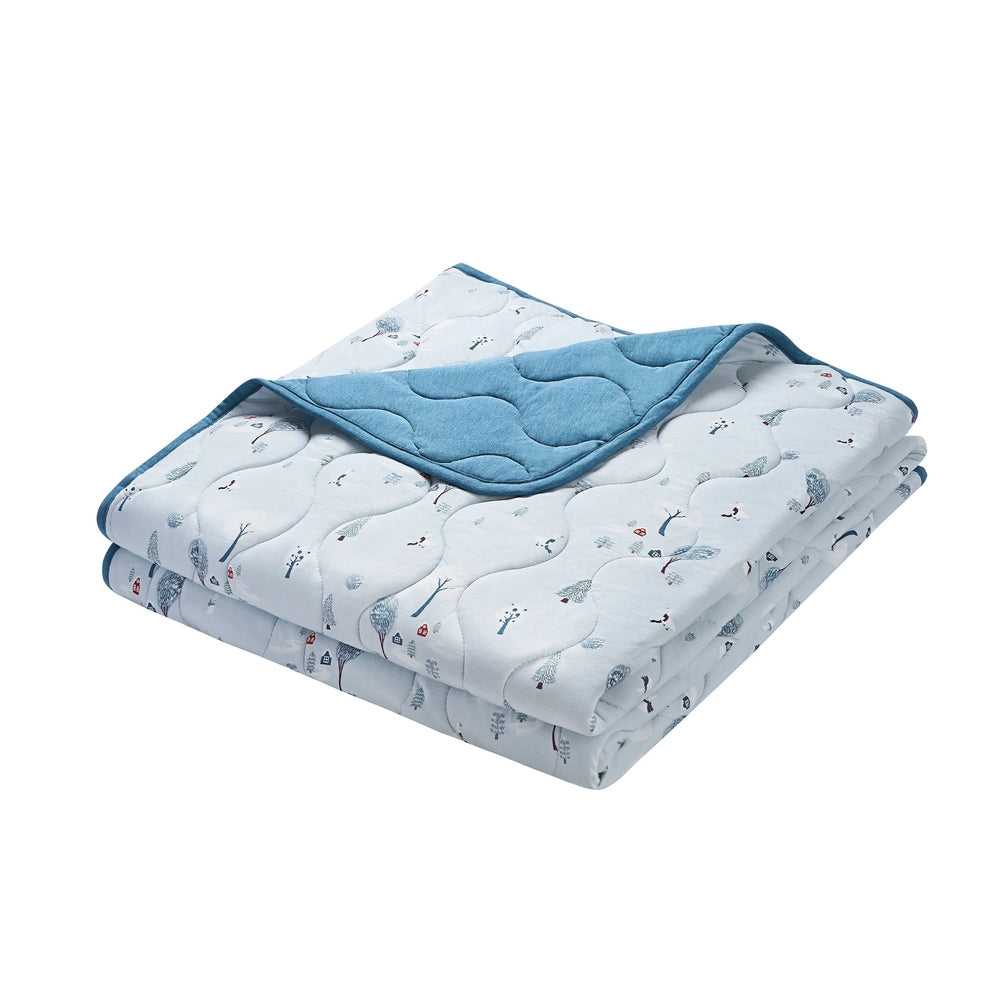 Nest Designs Bamboo Jersey Cozy Blanket Medium Snowy Snuggles, light blue with snow pattern; folded with blue reverse edge visible.