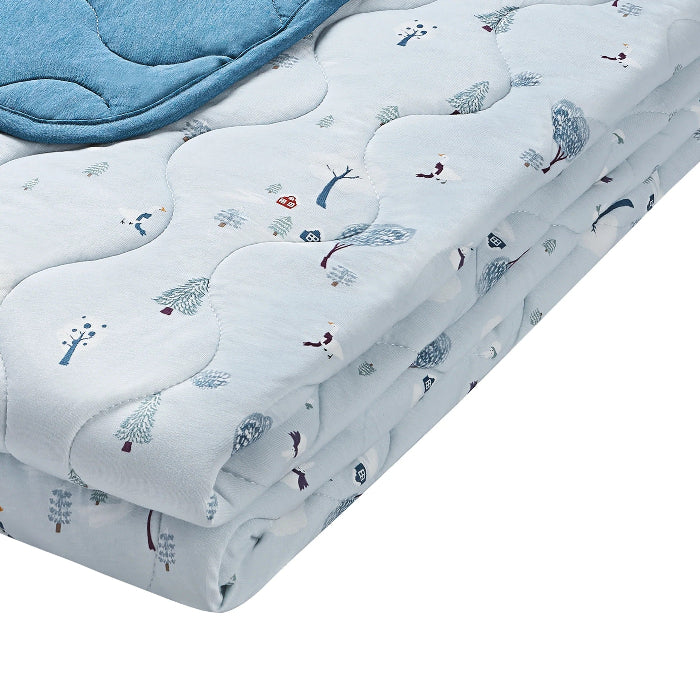 Nest Designs Bamboo Jersey Cozy Blanket Medium Snowy Snuggles in light blue, quilted with trees, folded for display.