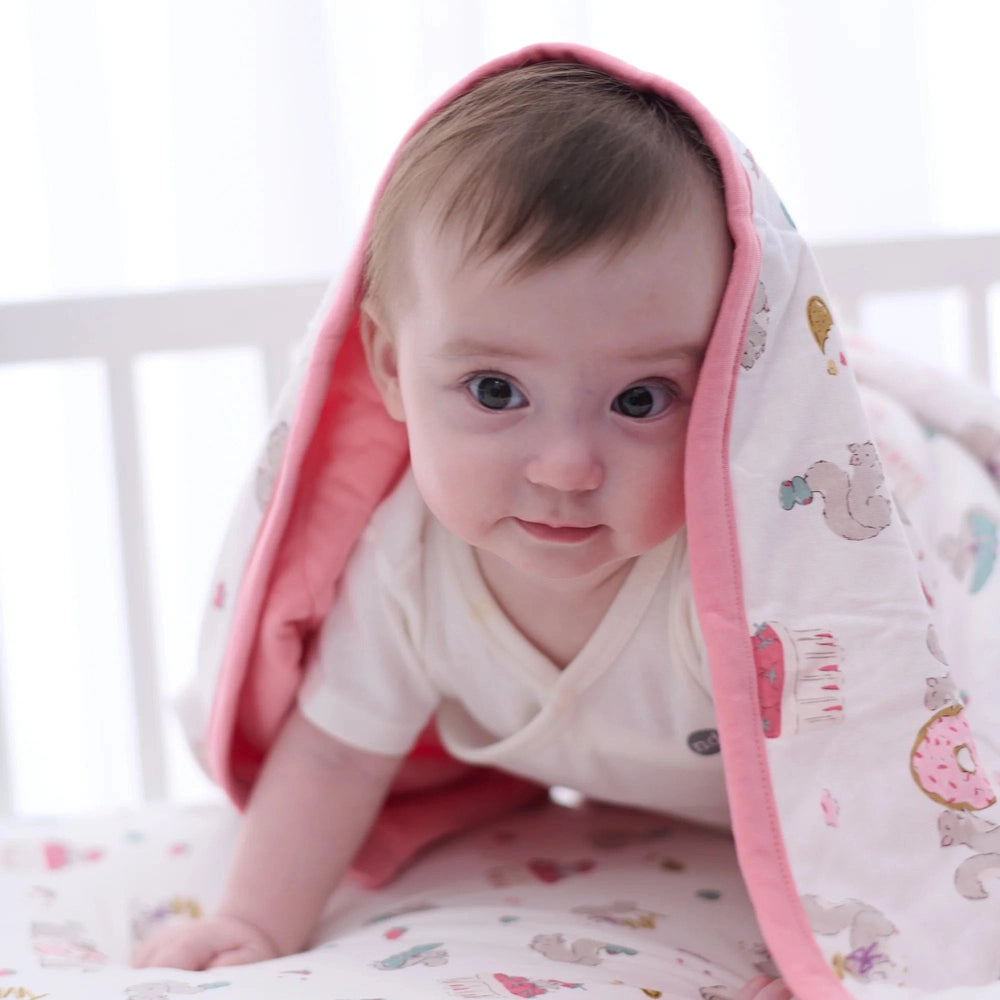 NEST DESIGNS Nest Designs Bamboo Jersey Quilted Cozy Blanket Very Squirrelly pink binding trim with whimsical animal and donut print img 3/6