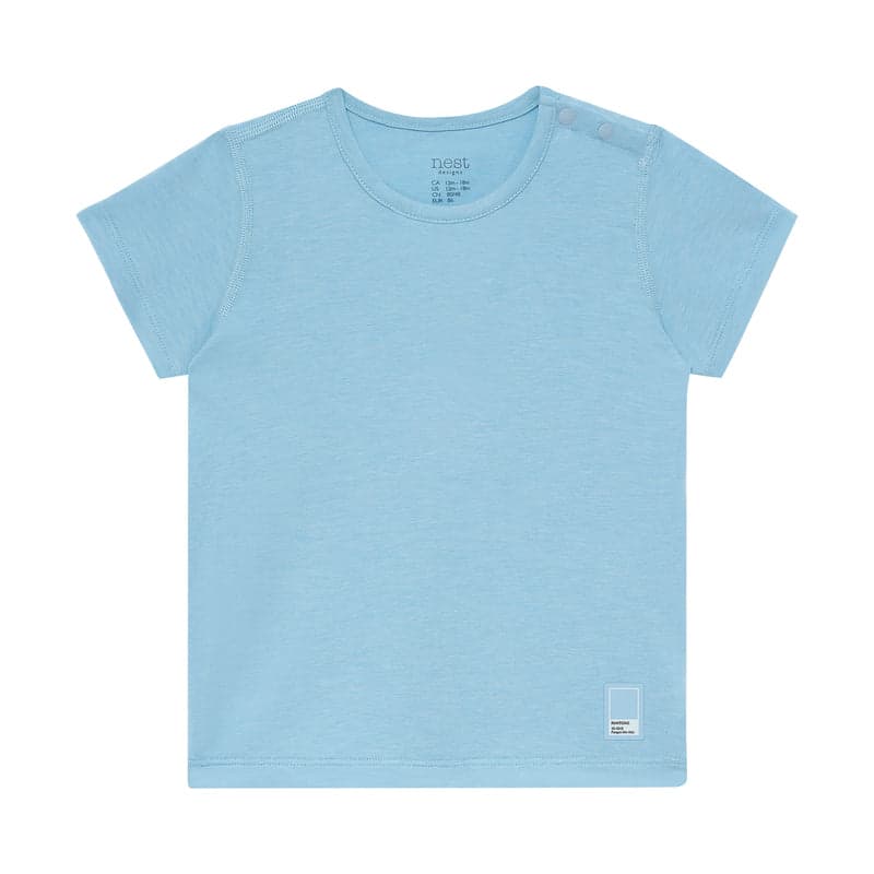 Nest Designs Bamboo Jersey Short Sleeve PJ Top Forget-Me-Not blue laid flat, highlighting soft kids' sleepwear.