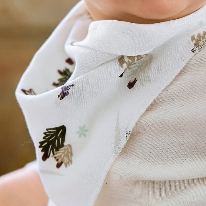 Nest Designs Bamboo Muslin Baby Bandana Bib Chills N' Thrills worn by baby; white bib with botanical print around neck.