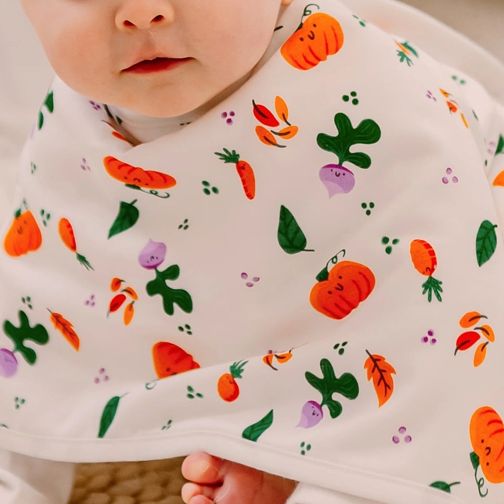 Nest Designs Bamboo Muslin Burp 'n Bib 2-Pack harvest print bibs for babies, white with pumpkins and veggies.