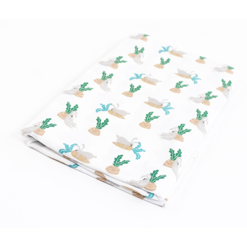 Nest Designs Bamboo Swaddle Blankie in white with pastel rabbit and carrot print, neatly folded to show soft, breathable fabric.