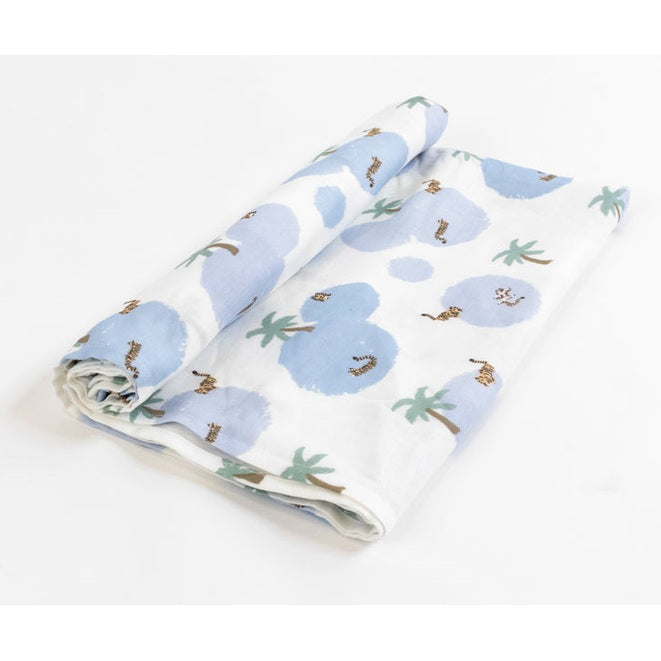 Nest Designs Bamboo Swaddle Blankie, white with blue clouds and palm trees, neatly rolled for easy use.