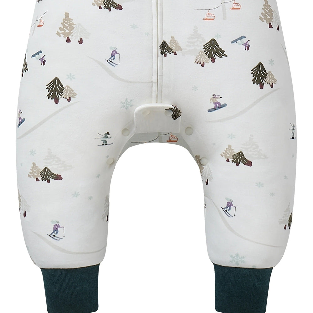 Nest Designs Cotton Long Sleeve Footed Sleep Bag 1.0 Tog in white ski-pattern; baby's feet stay warm as she moves.