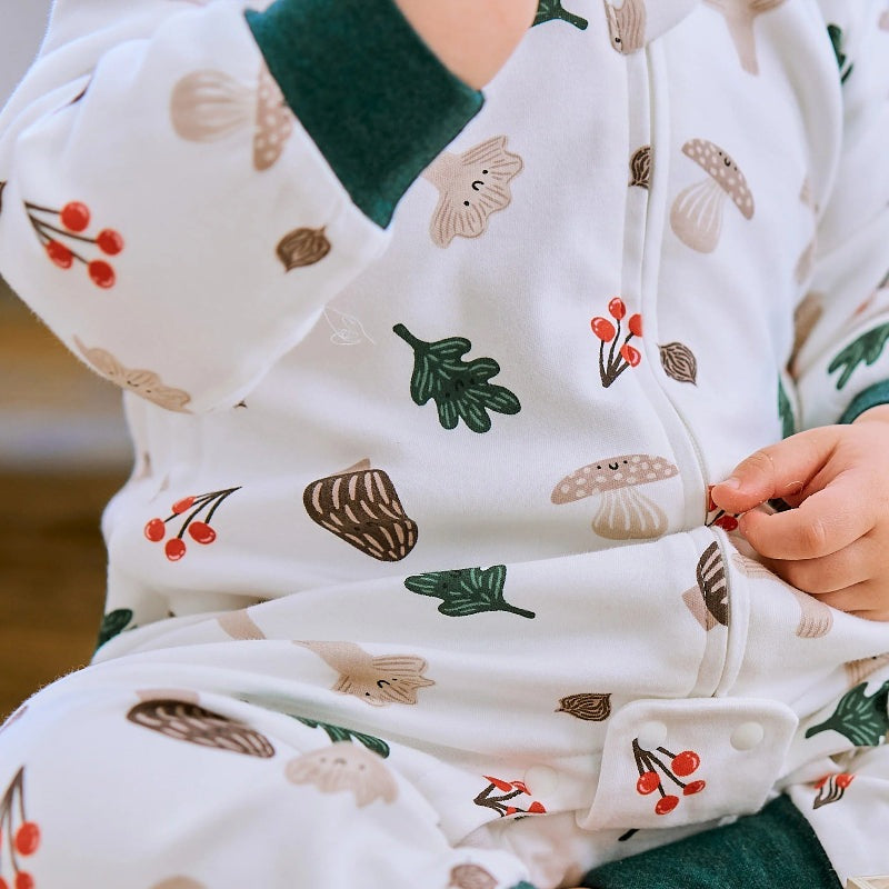 Nest Designs cotton footed sleep bag in white Forest Forage print with mushrooms and leaves; green cuffs