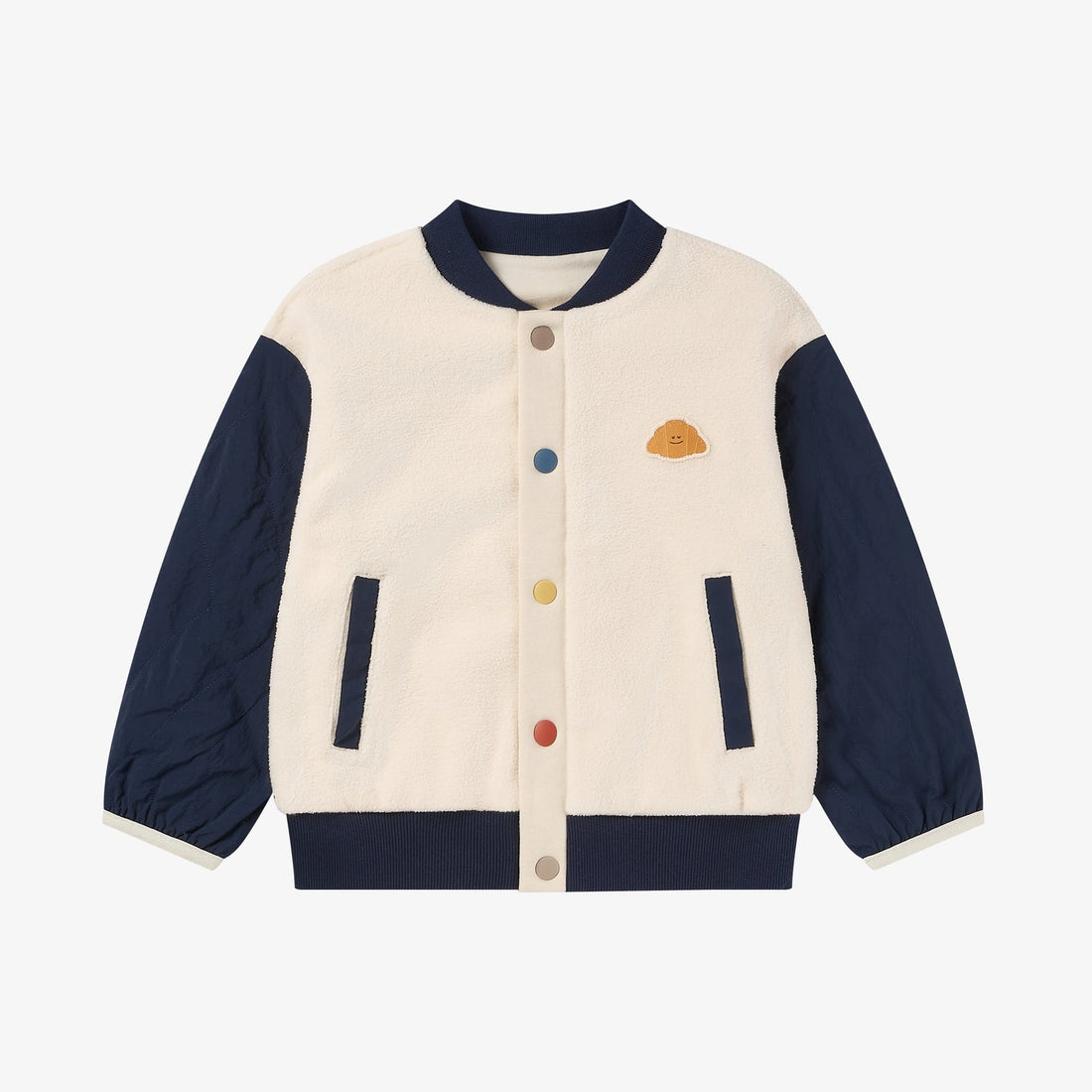 Nest Designs Cozy Croissant Fleece Jacket in Blueberry, front view with cream fleece body, navy quilted sleeves and multicolour snaps