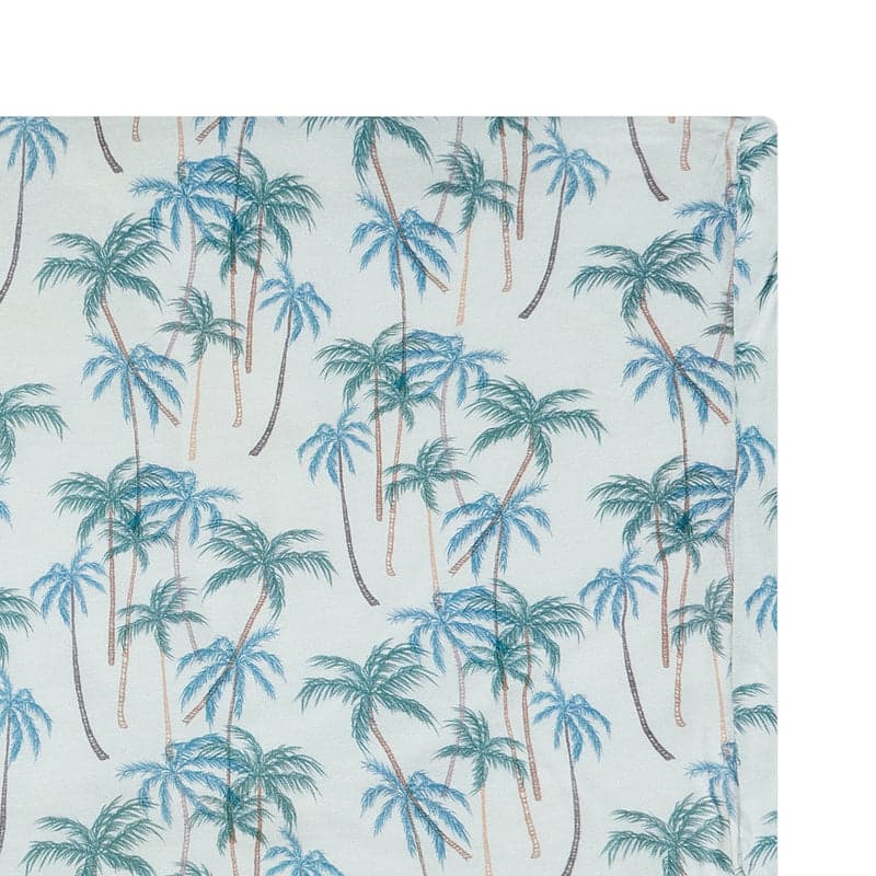 Nest Designs foam pillow with bamboo jersey pillowcase in Coco Beach palm print on blue fabric.