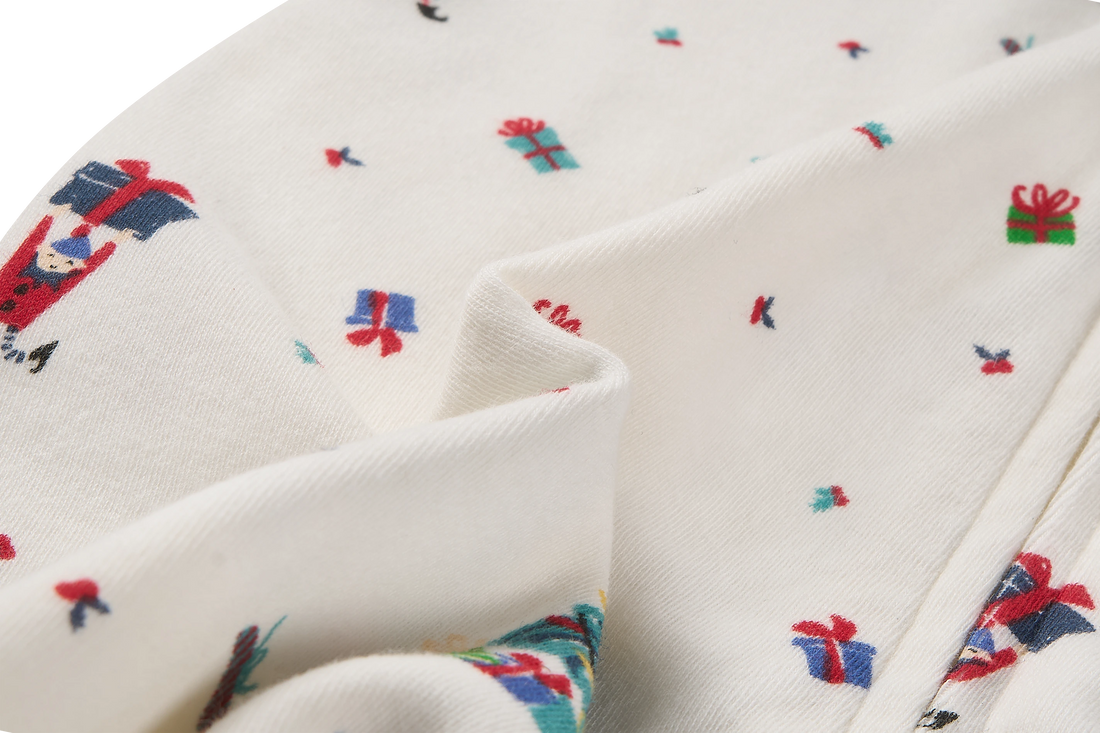 Nest Designs Santas Elves: close-up of the footed sleeper knit and Santa Elves print