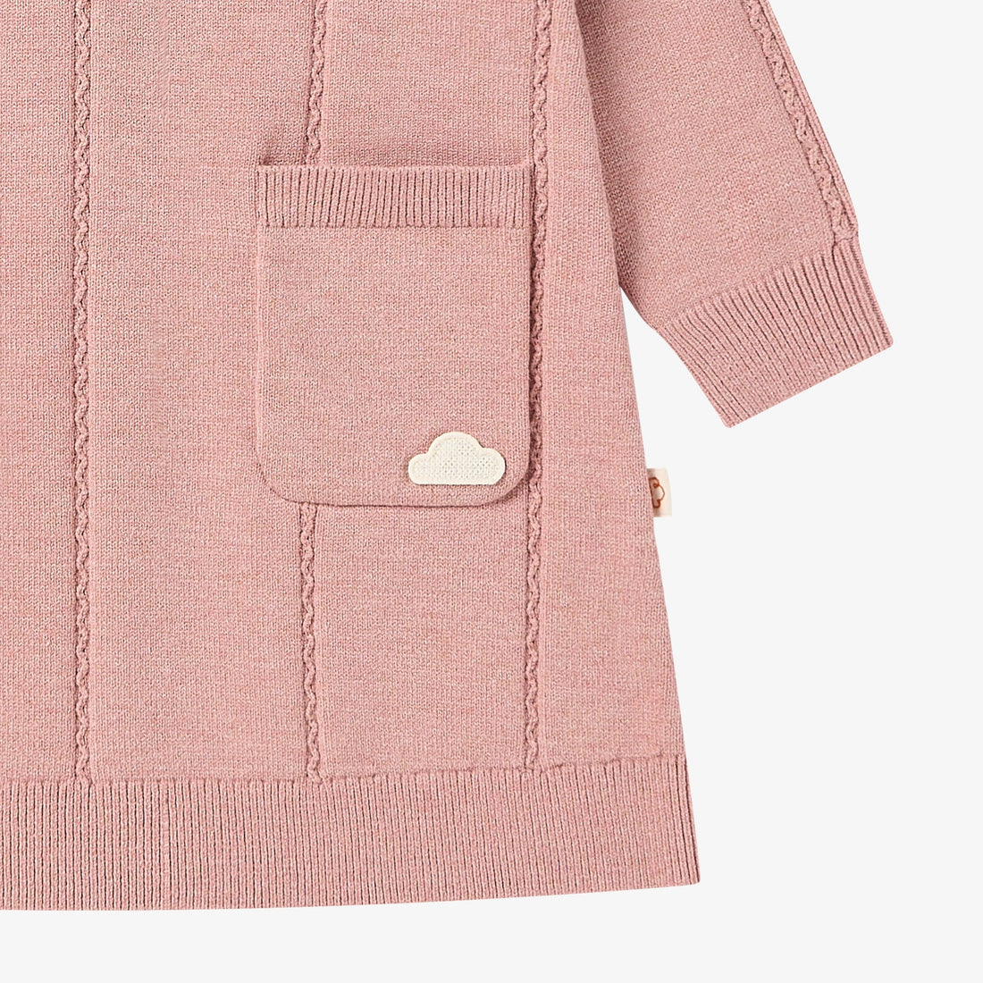Nest Designs Rose Cable Knit Dress in Old Rose, lower detail with cloud-accent pocket, ribbed hem, and cuff