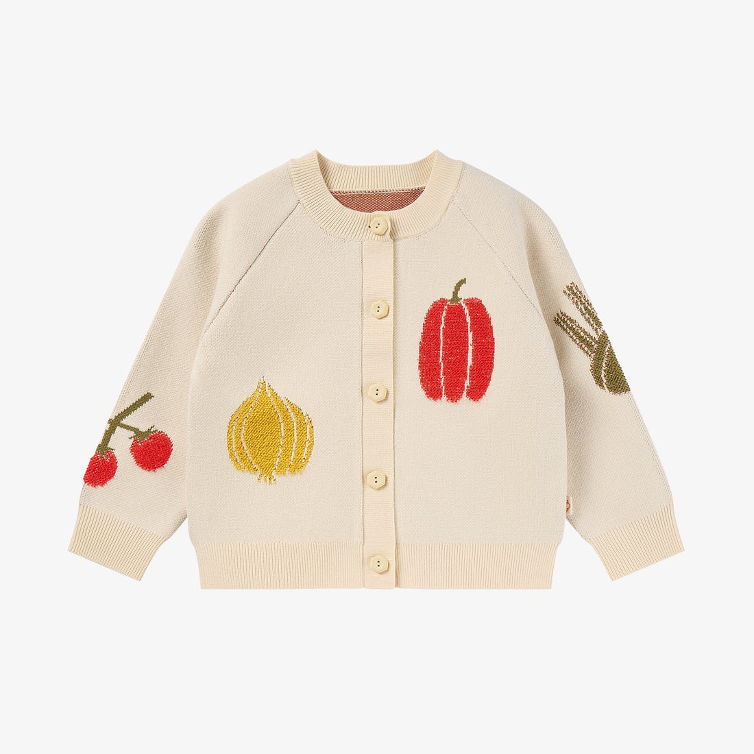 Nest Designs Jet Stream cream knit cardigan, front studio view with spaced red, yellow, and green vegetable motifs