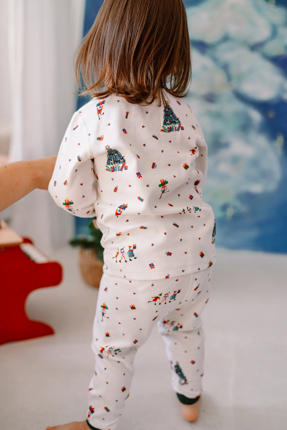 Nest Designs Santas Elves: back view of a child wearing the matching pajama top and pants