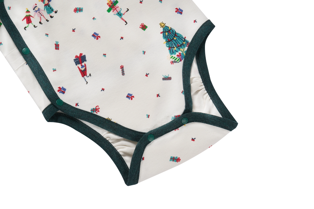 Nest Designs Santas Elves: close-up of the kimono onesie bottom snap closure and green leg binding