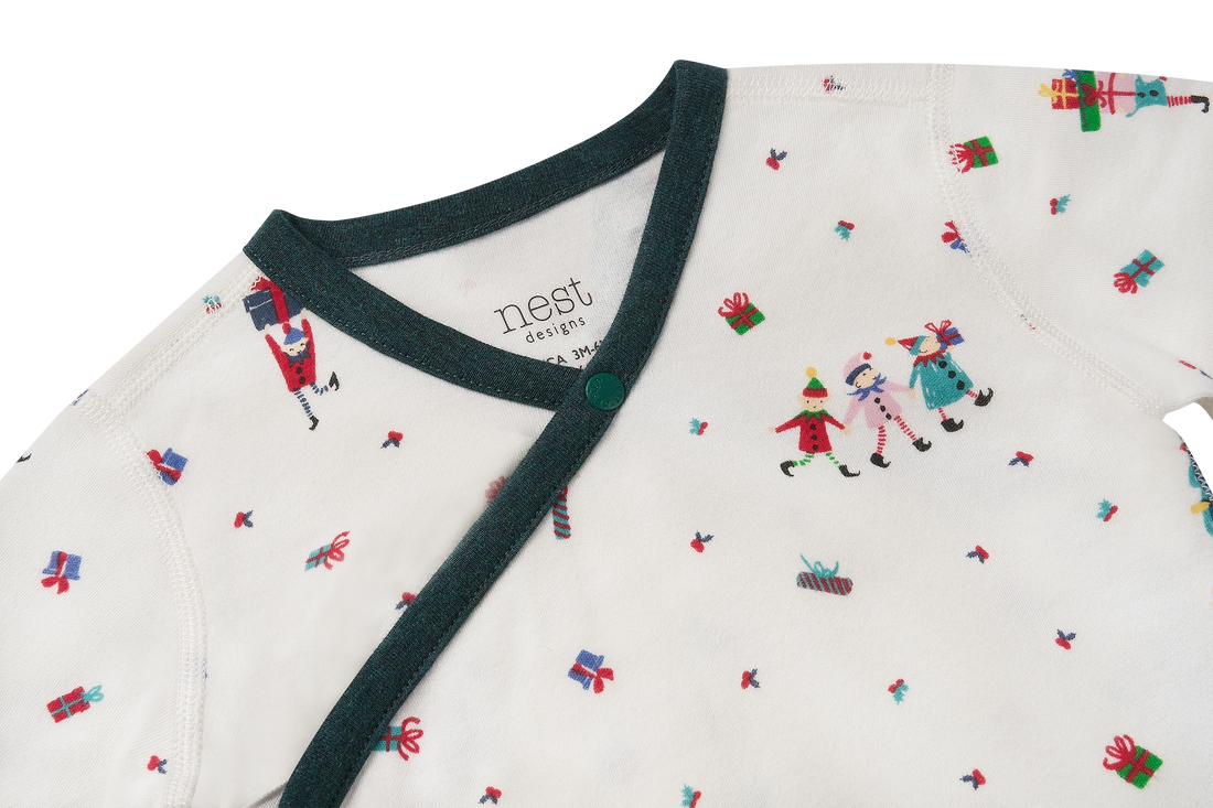 Nest Designs Santas Elves: close-up of the closed crossover neckline and green trim