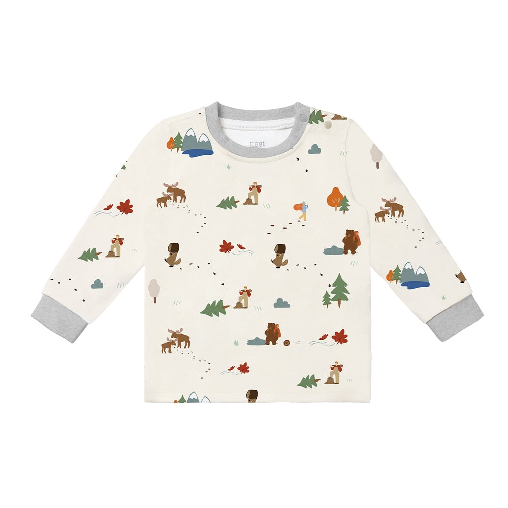 Nest Designs Timber long-sleeve pajama top in cream with woodland print and gray cuffs, flat lay