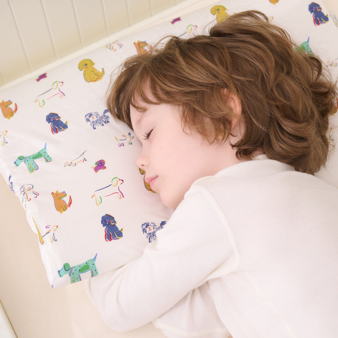 Toddler sleeping on the Bingo animal print Nook pillow