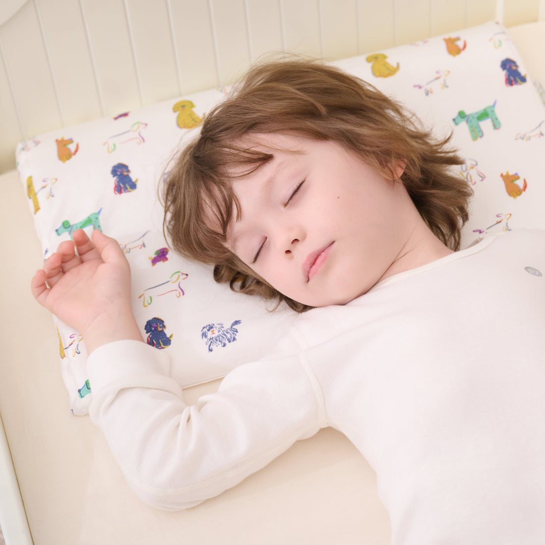 Overhead view of toddler resting on the Bingo Nook pillow