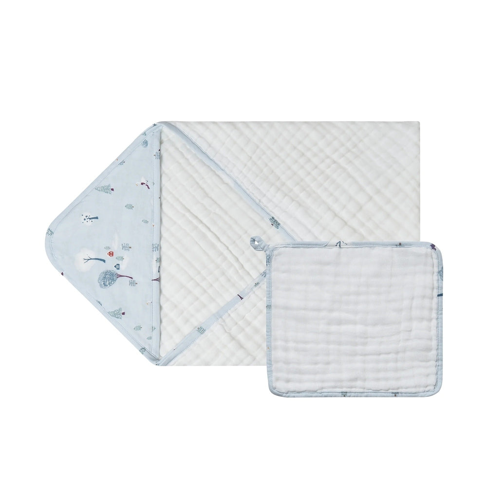 Nest Designs Organic Cotton 9-Layer Hooded Baby Bath Towel Snowy Snuggles; light-blue hooded towel spread with forest print.