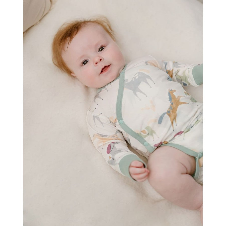 Nest Designs Pony Express Organic Cotton Long Sleeve Kimono Onesie in White with pastel dinosaur print and mint trim
