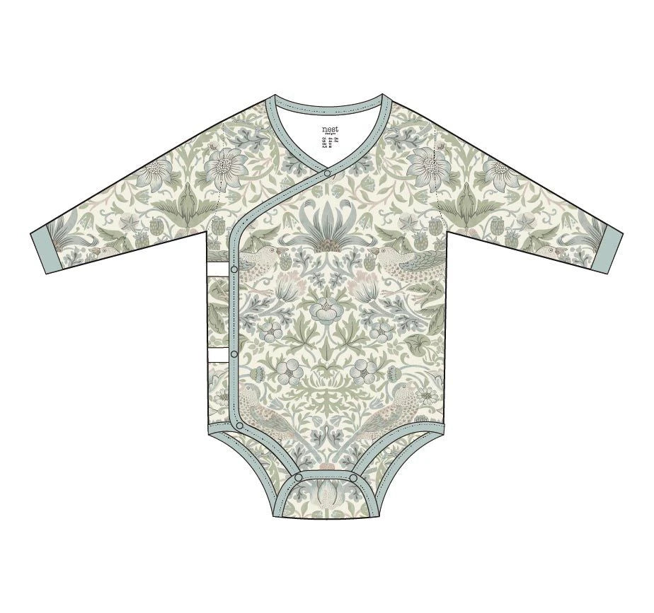 A long-sleeve baby bodysuit with an intricate botanical and floral pattern in muted sage green, beige, and gray tones, featuring a light blue-gray trim and snap closures down the front.
