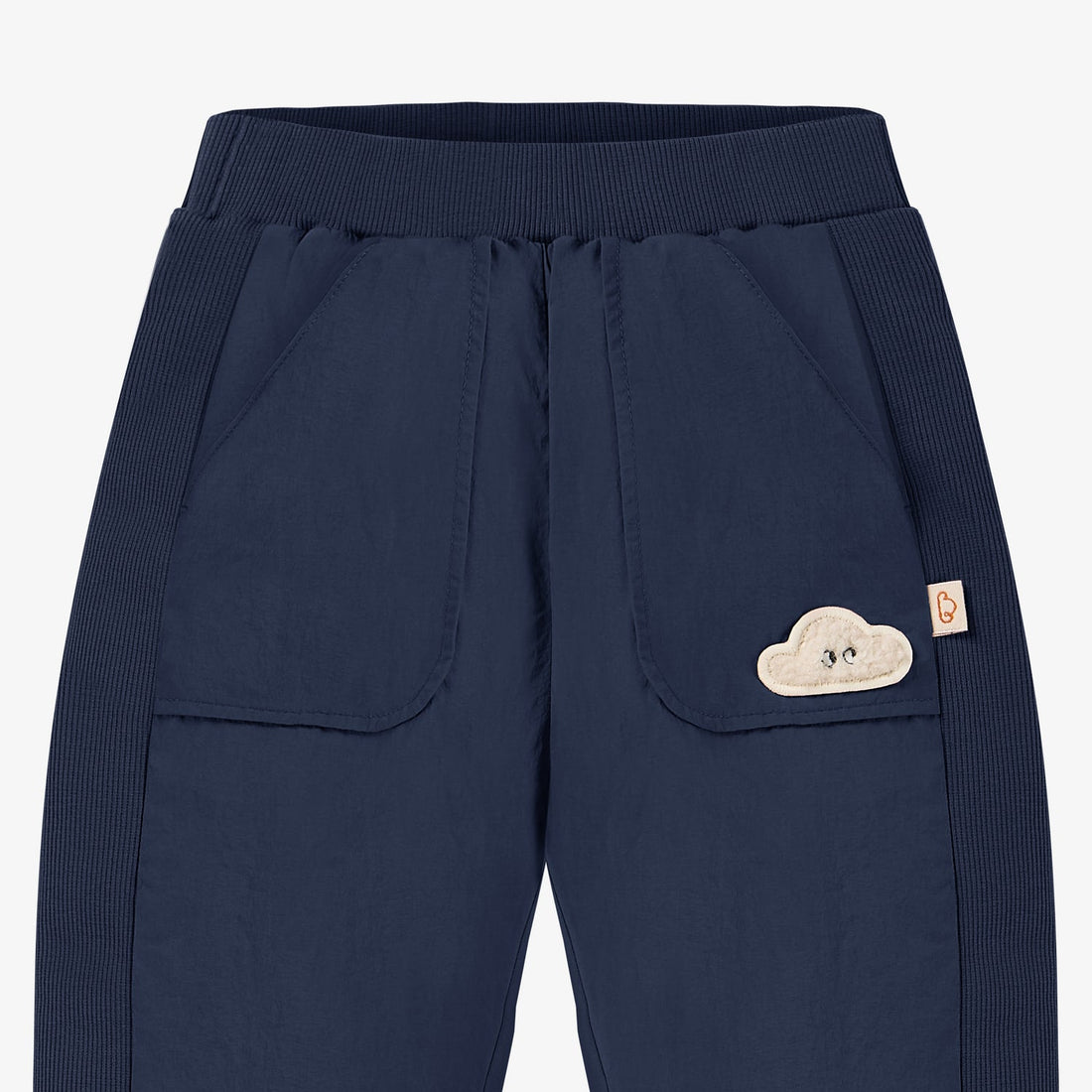 Nest Designs Nylon Pants in Blueberry navy, waist close-up with elastic band, large pockets, and cloud patch