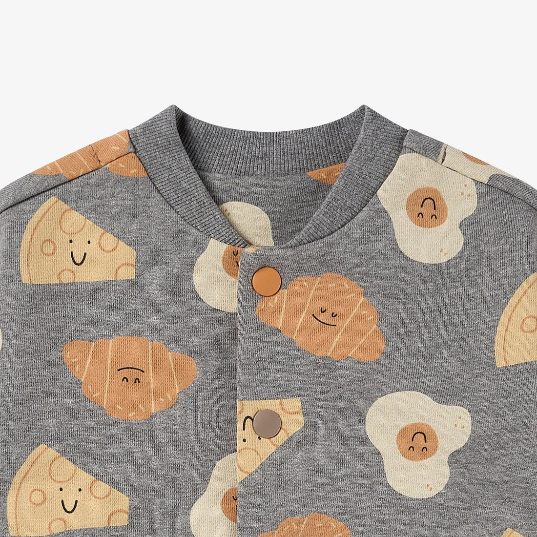 Nest Designs Smiley Side Up baseball jacket neckline detail with grey ribbed collar, orange snap and smiling food illustrations
