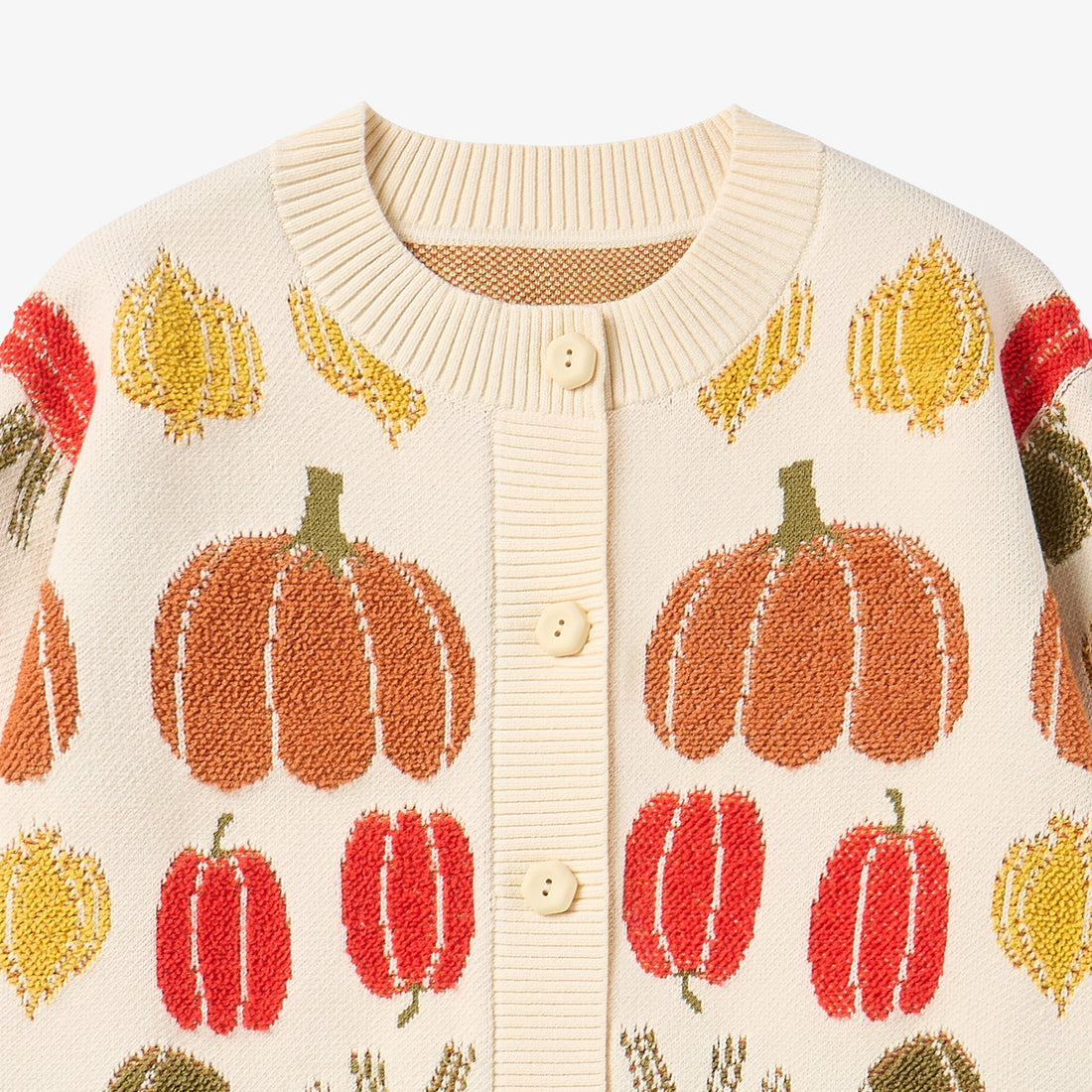 Nest Designs Veggie Jacquard Cardigan in Veggie Tales cream, upper close-up with large pumpkin and ribbed neckline