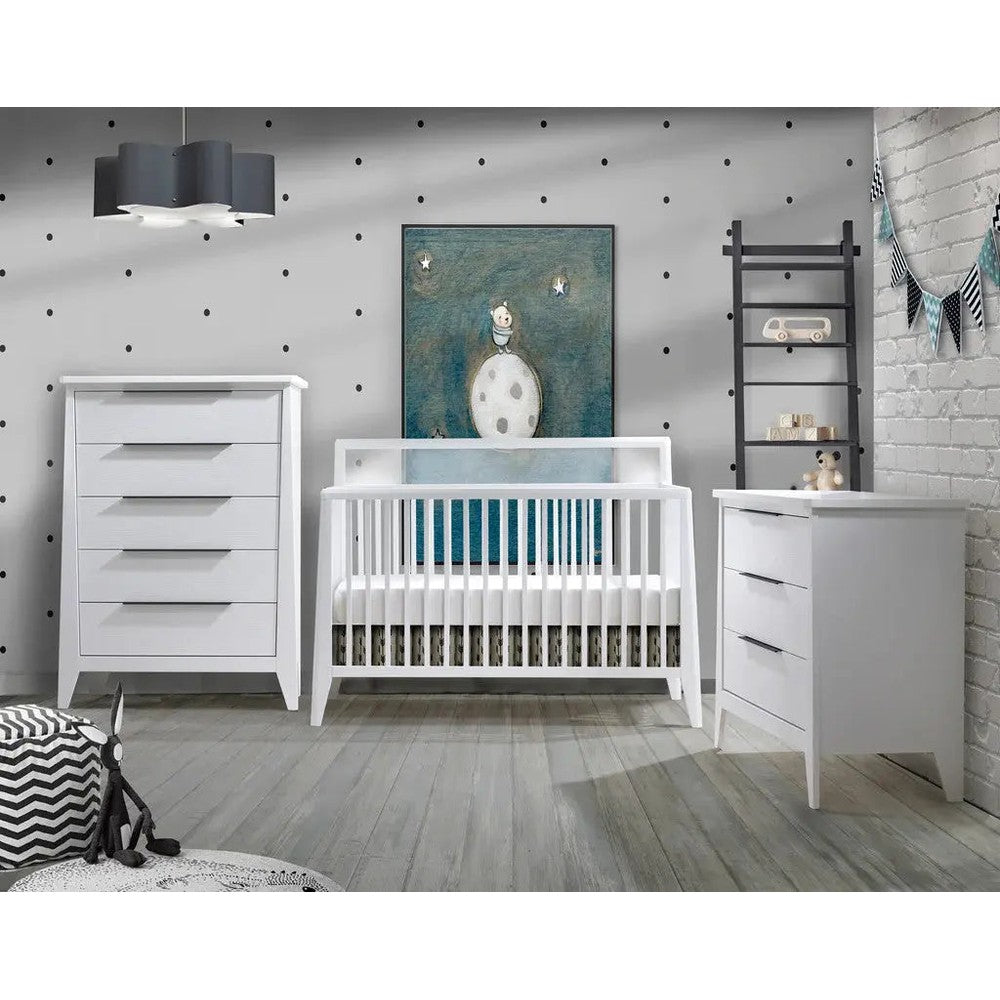 Nest Flexx Premium 5-Drawer Dresser in white beside a white crib in a modern baby nursery.
