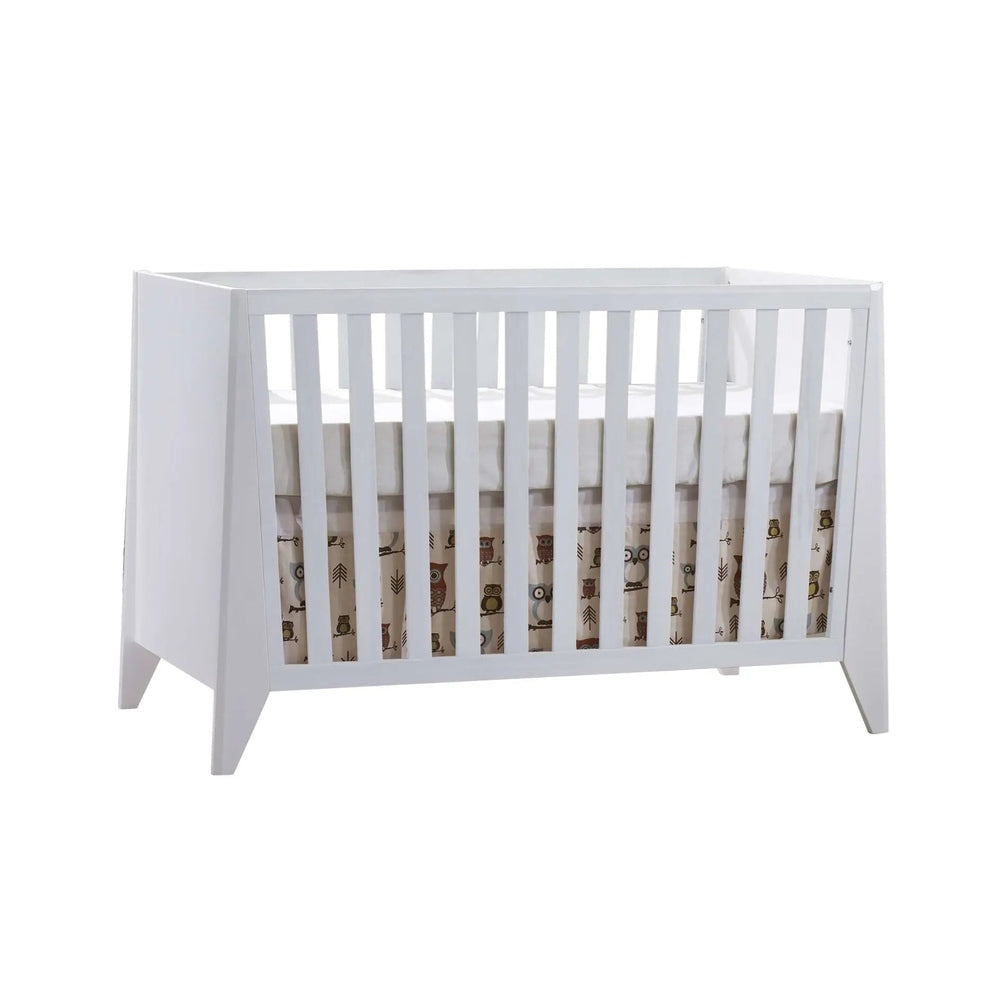 Nest Flexx Premium Classic Crib Natural Birch in white-painted wood with vertical slats and woodland-themed skirt.