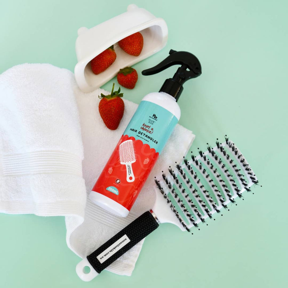 No Nasties Kids Strawberry Hair Detangler, 250 ml bottle with spray nozzle, shown with detangling brush.