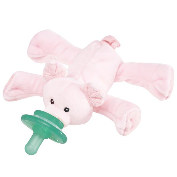 Nookums Paci-Plushies Pig Shakies pink plush pig with a green pacifier in its mouth.