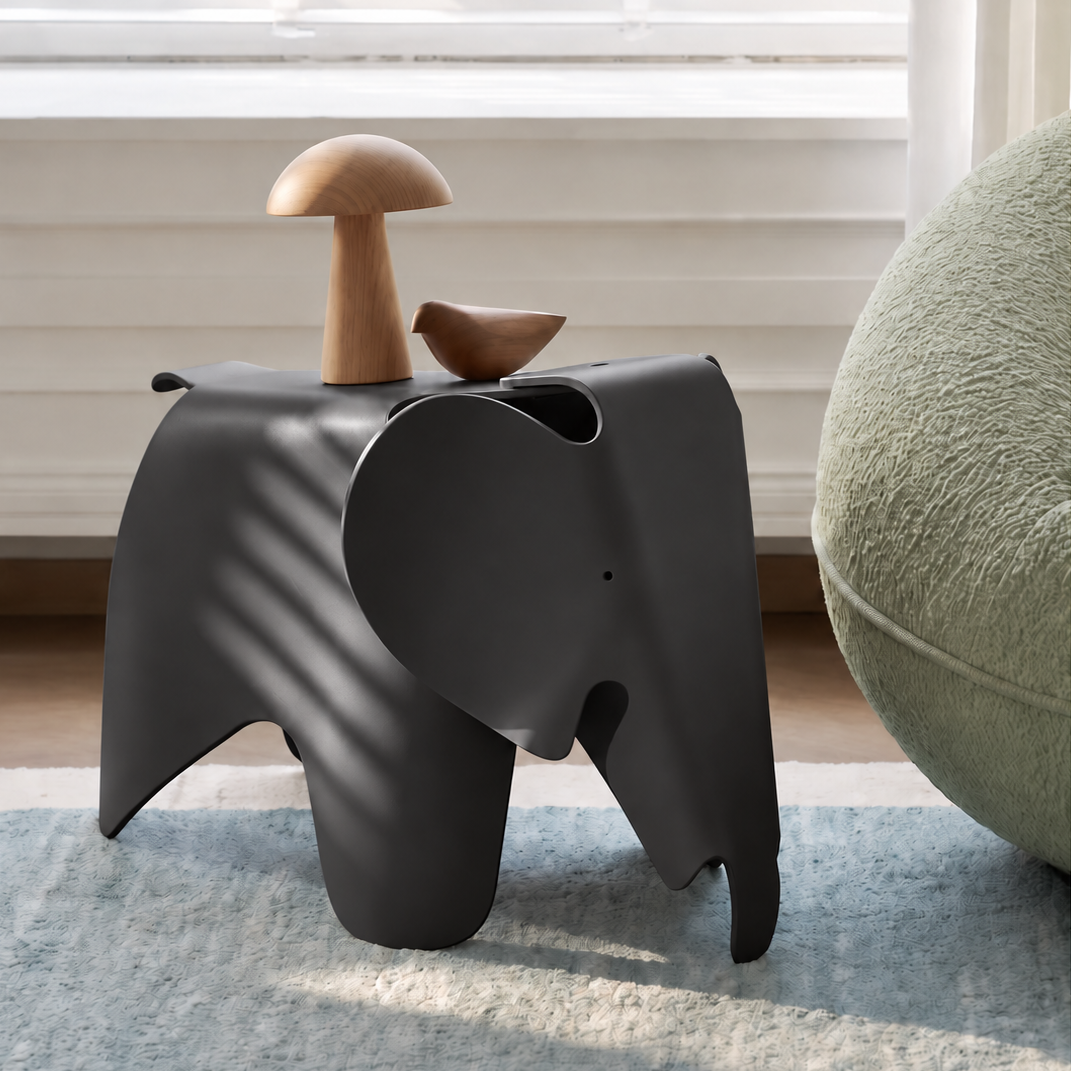Black NORDIC Elephant Chair beside a sofa in a sunlit room