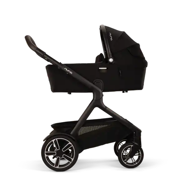 Nuna DEMI next Bassinet in Caviar mounted in the upper stroller position