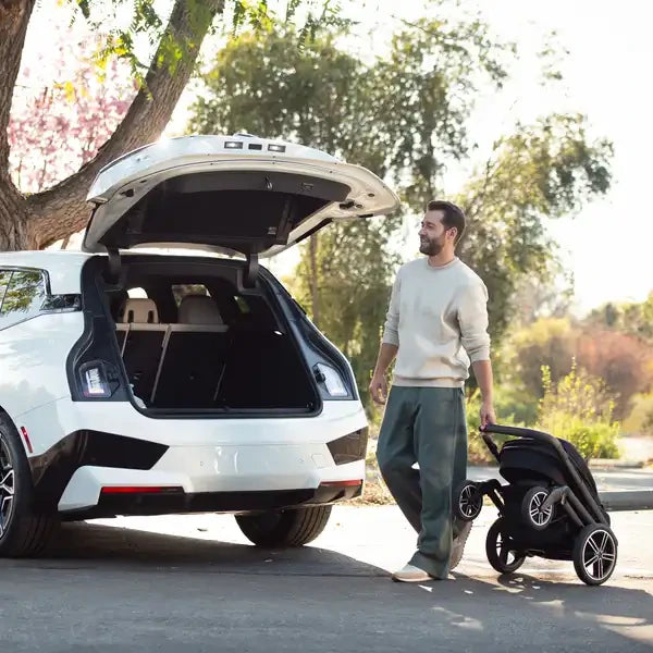 Nuna MIXX Next beside a car for travel