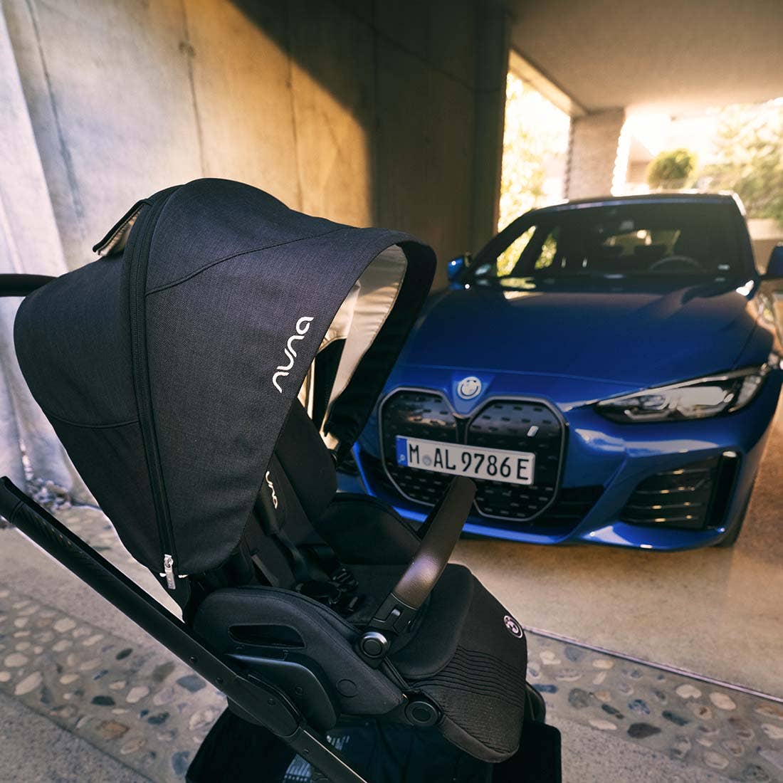 Nuna MIXX next Stroller — black stroller canopy close-up beside a blue car